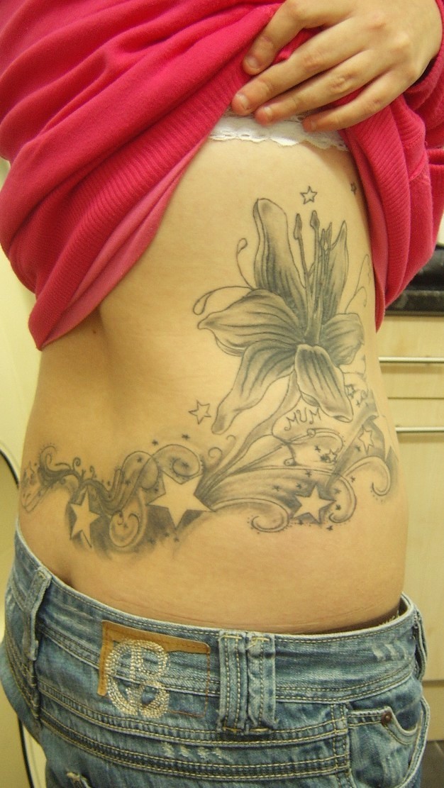 Black Tattoo flower rib tattoos. Black Tattoo