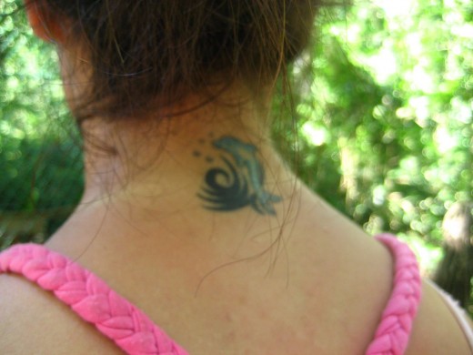 tattoos on neck for girls. Dolphin Neck Small Tattoo